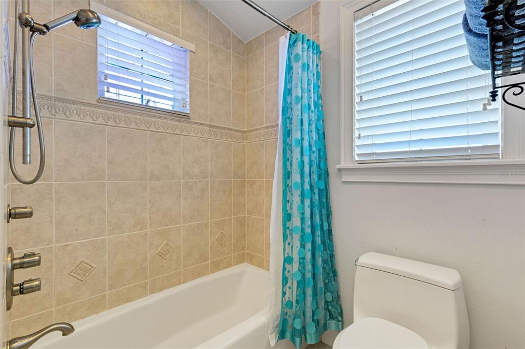 13423 Gulf Lane Madeira Beach, FL 33708 - Photo 51 of 71 a bathroom with a toilet and shower