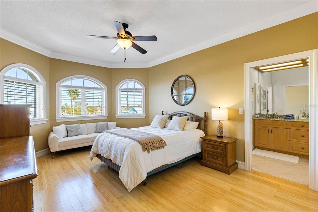 13423 Gulf Lane Madeira Beach, FL 33708 - Photo 52 of 71 a bedroom with a bed and a chandelier