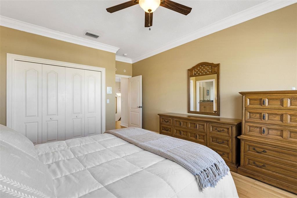 13423 Gulf Lane Madeira Beach, FL 33708 - Photo 55 of 71 a bedroom with a bed and a chandelier