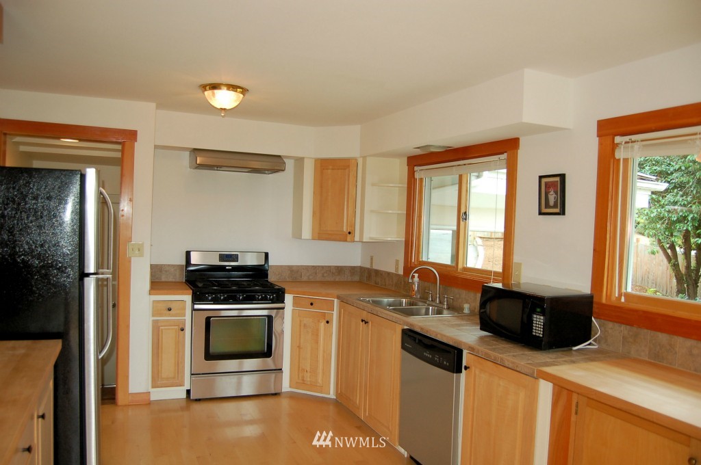 504 Briar Road Bellingham, WA 98225 - Photo 14 of 25 a kitchen with stainless steel appliances a stove a sink a microwave a refrigerator and cabinets