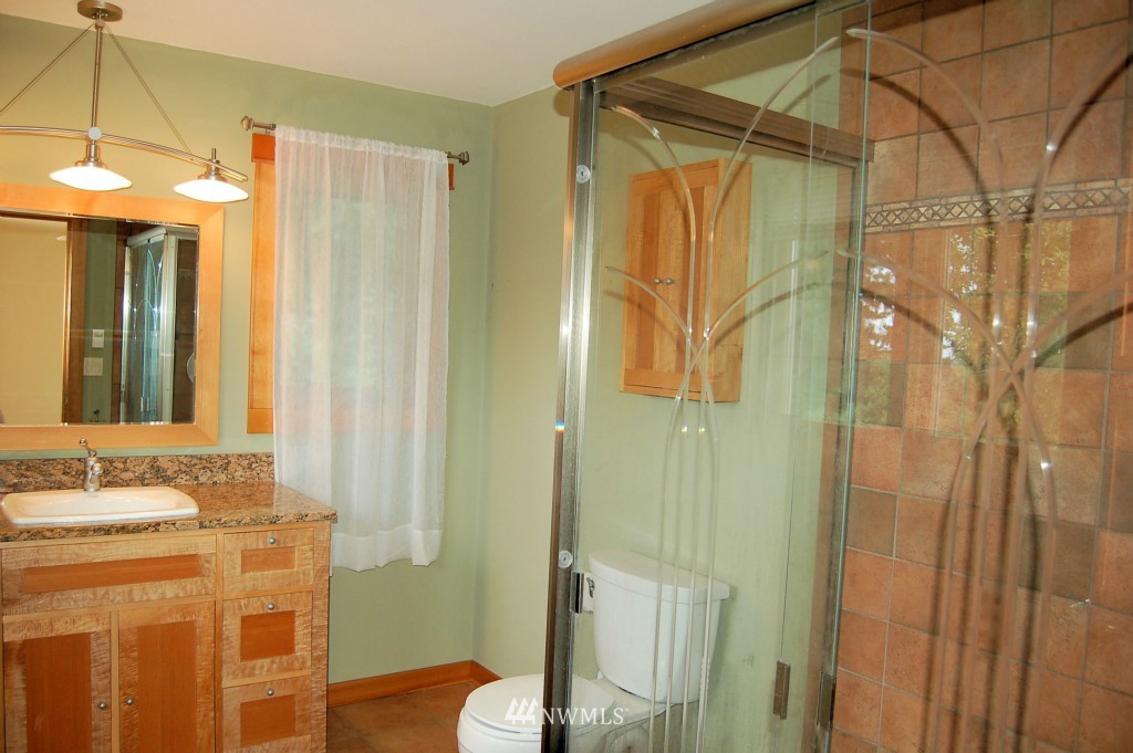 504 Briar Road Bellingham, WA 98225 - Photo 21 of 25 a bathroom with a granite countertop sink and a mirror
