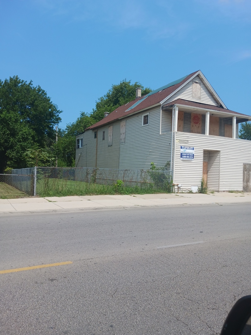 a front view of a house with a garage and a yard