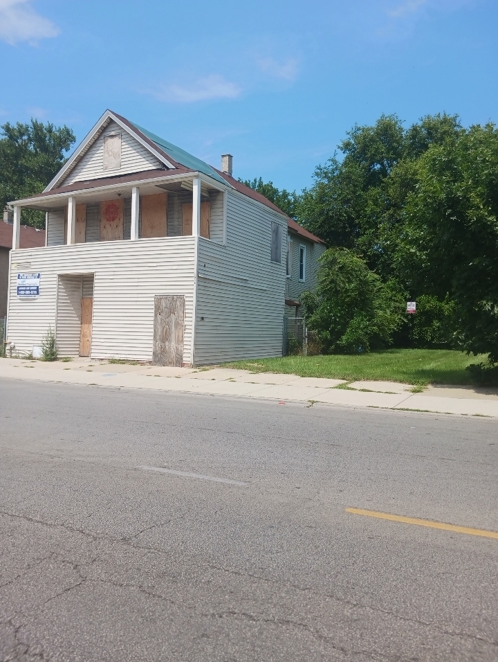 2856 East 79th Street Chicago, IL 60649 - Photo 2 of 5 a front view of a house with a yard and garage