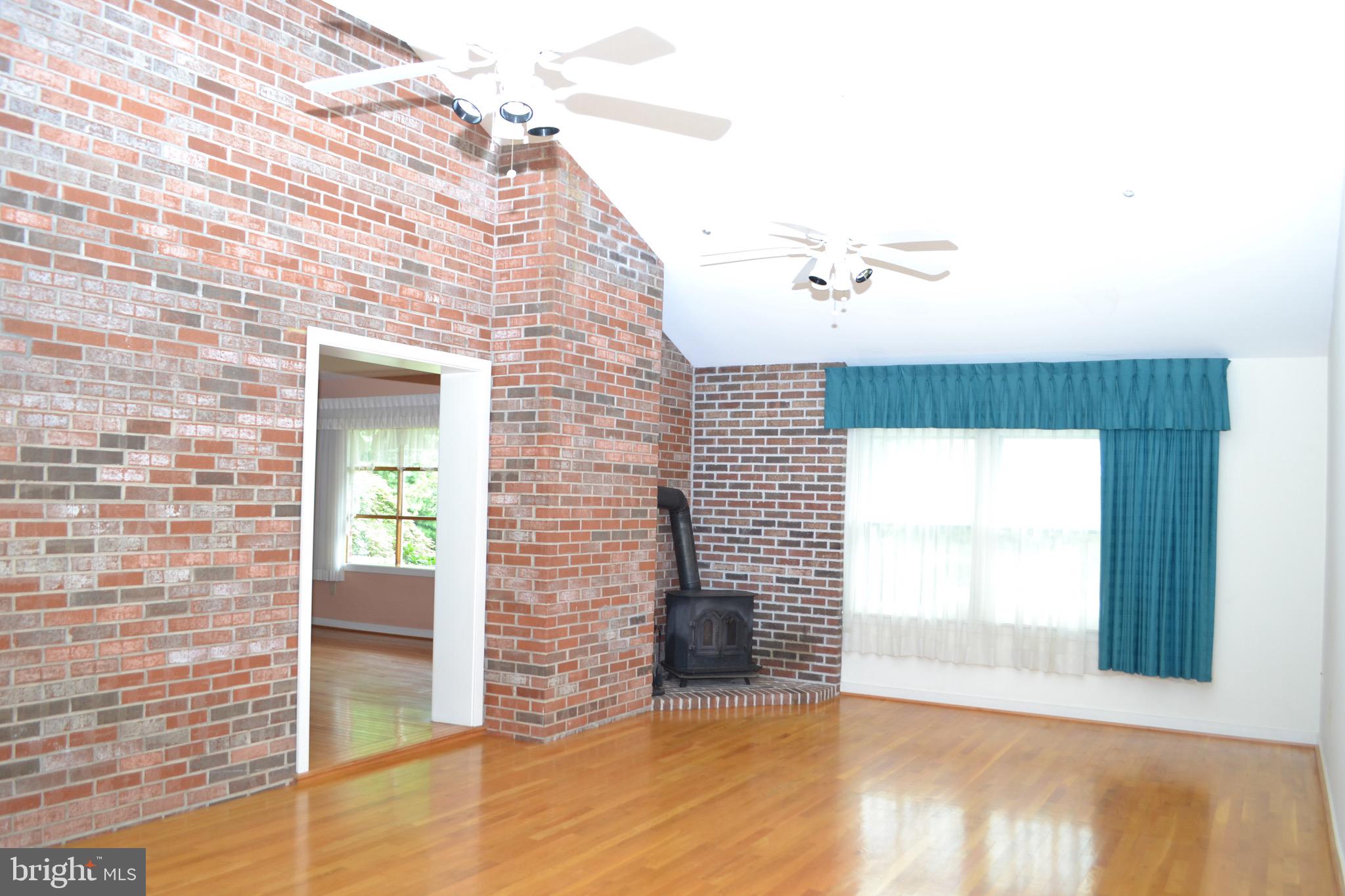 6144 King Road Boonsboro, MD 21713 - Photo 6 of 31 Great room shows off exposed brick!