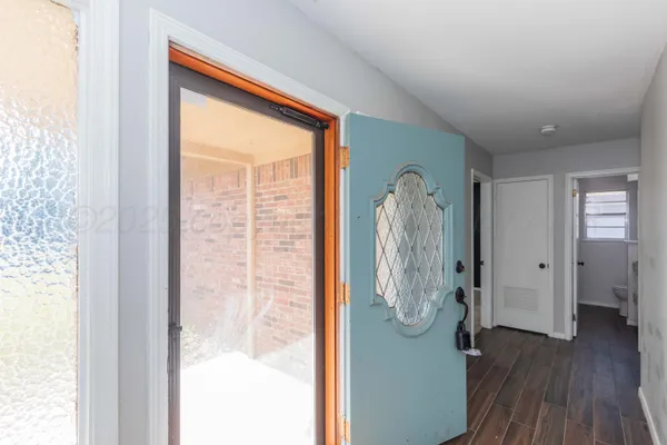 a view of a livingroom with wooden floor and door