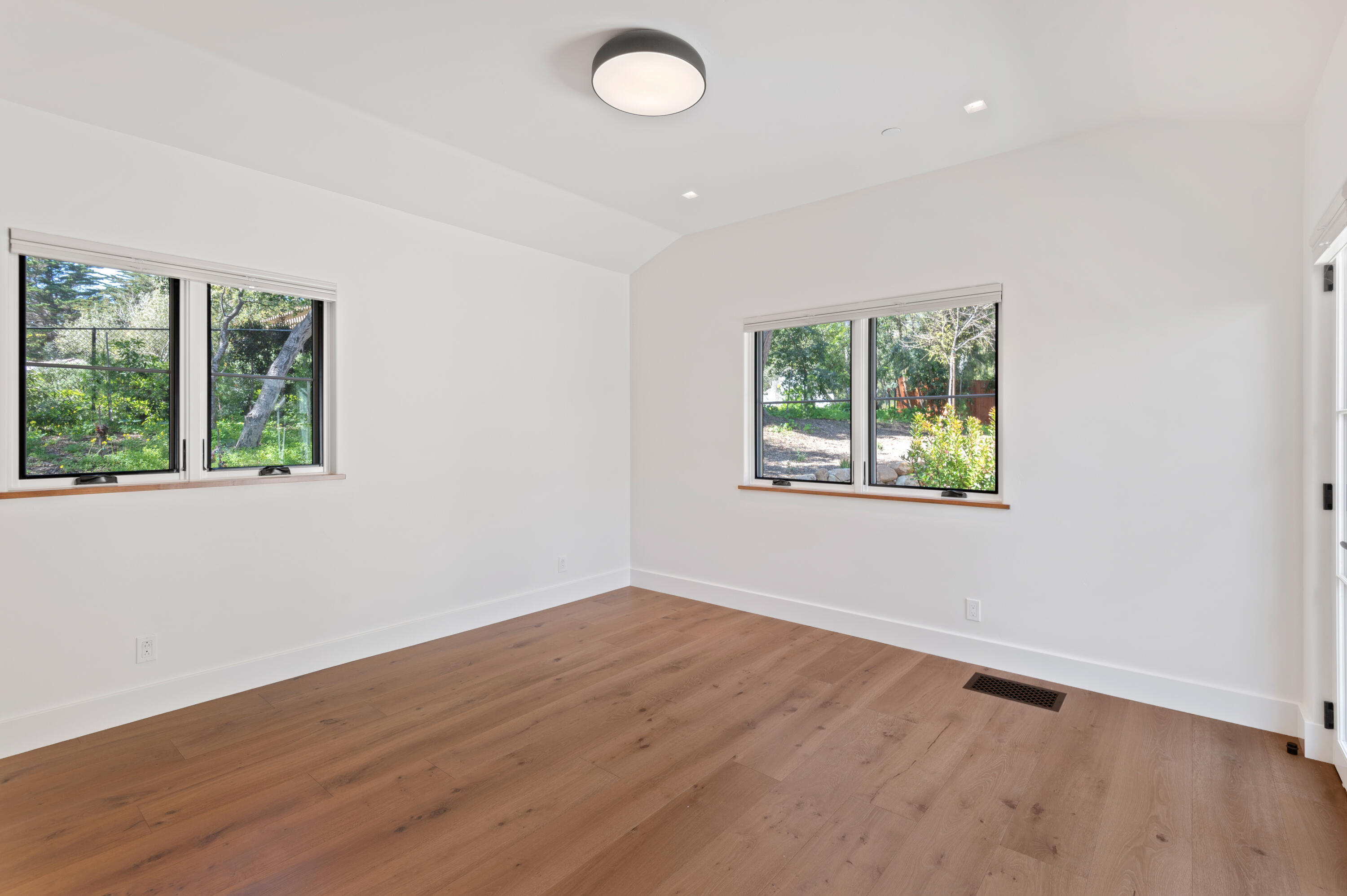 427 Pimiento Lane Montecito, CA 93108 - Photo 19 of 22 an empty room with wooden floor and windows