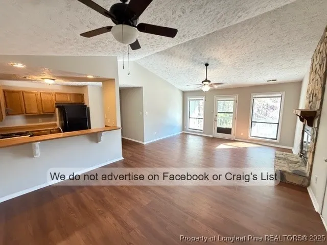 a view of a living room with hardwood floor and a ceiling fan