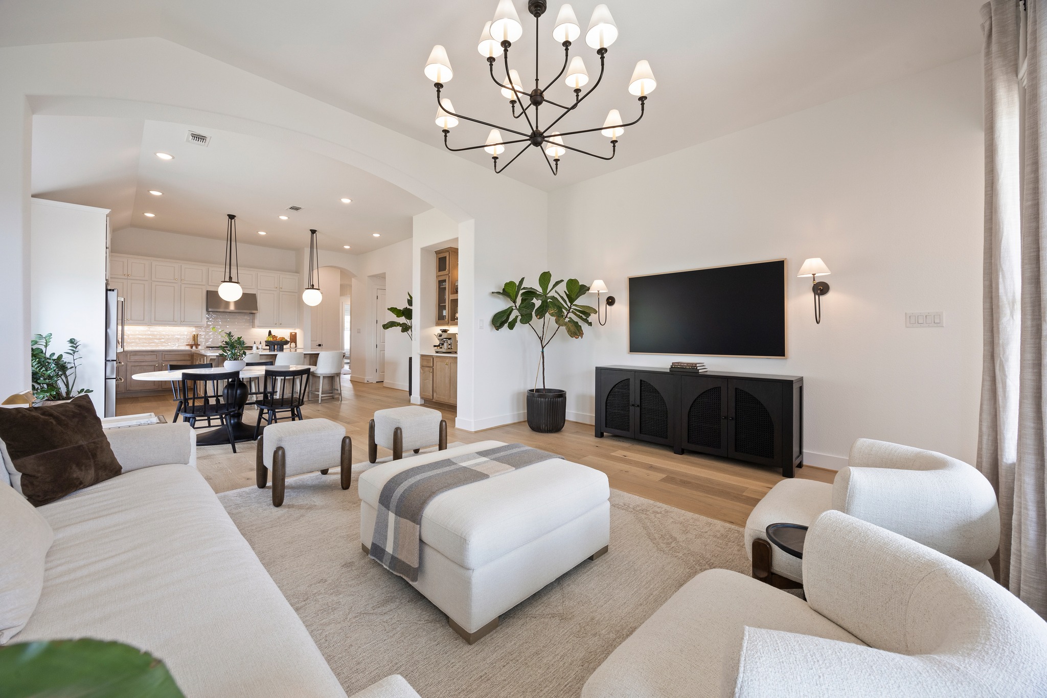 1204 Addison Lane Georgetown, TX 78628 - Photo 10 of 35 The space feels both grand and intimate, highlighted by a designer chandelier and a layout that effortlessly connects the living space to the kitchen and dining areas for ultimate entertaining potential.