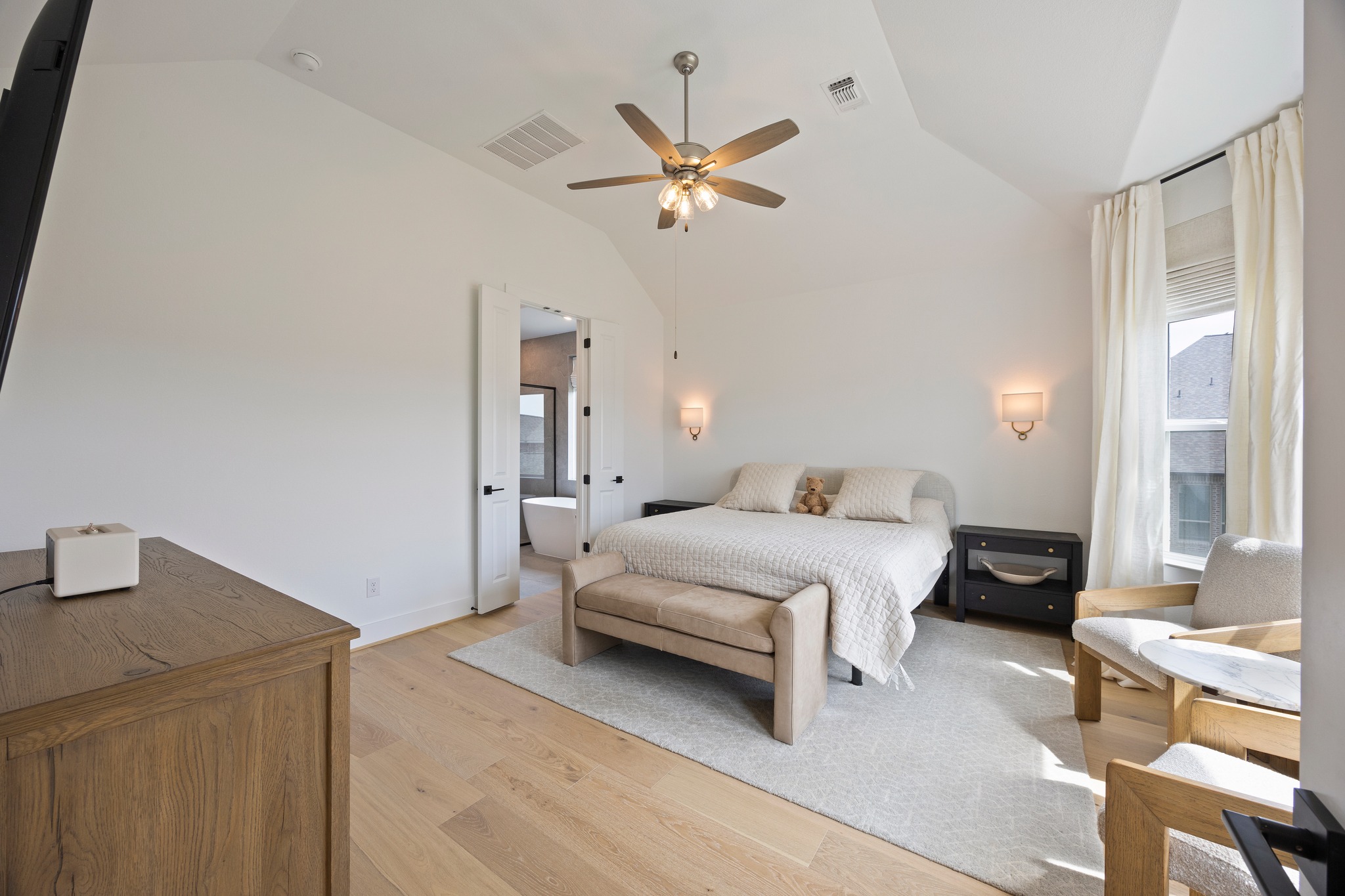 1204 Addison Lane Georgetown, TX 78628 - Photo 11 of 35 The primary suite is a true sanctuary, featuring vaulted ceilings and wide-plank oak flooring.