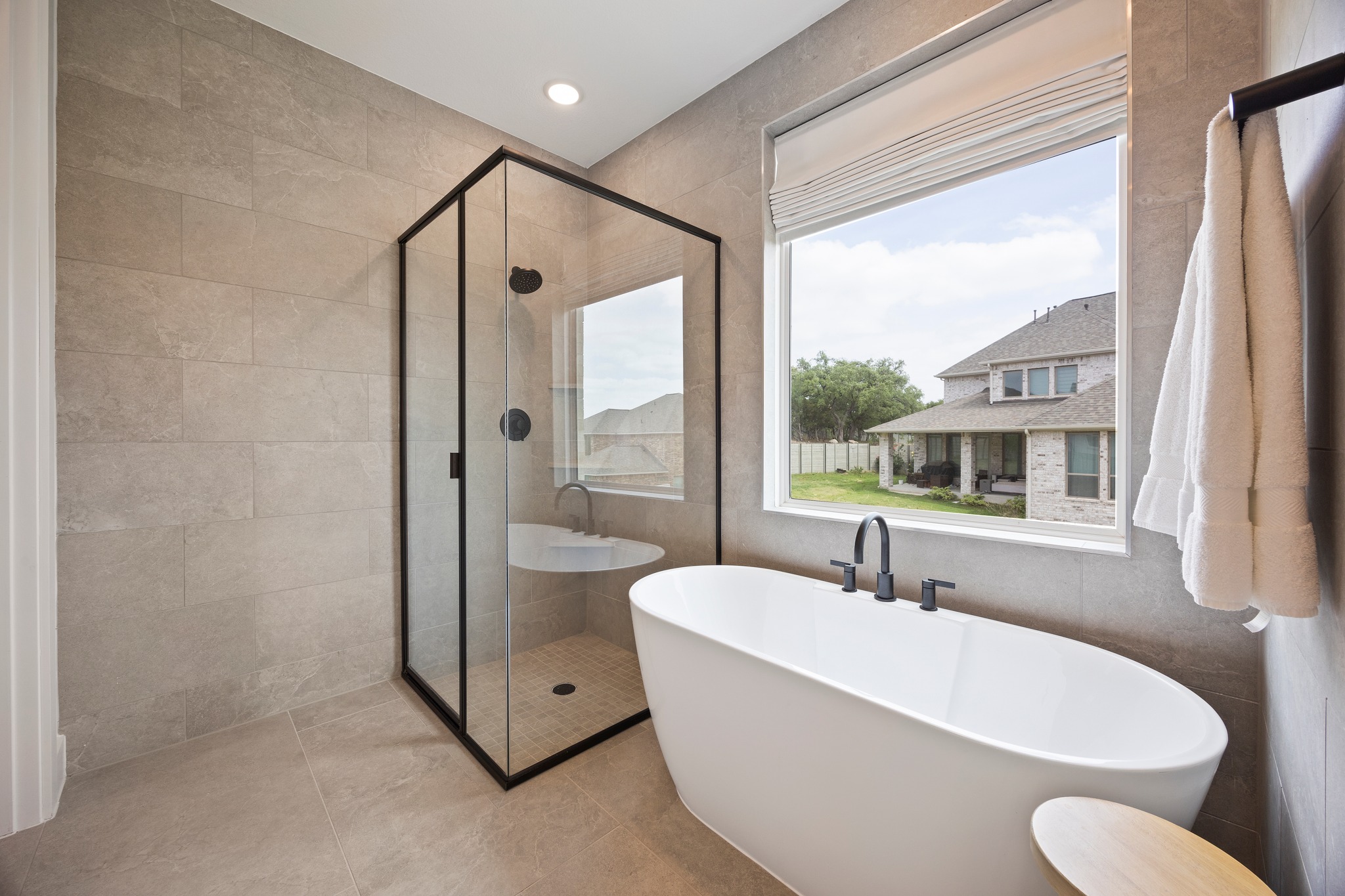 1204 Addison Lane Georgetown, TX 78628 - Photo 15 of 35 The wet area is the showstopper, featuring a freestanding soaking tub set against floor-to-ceiling stone tile and a walk in shower.
