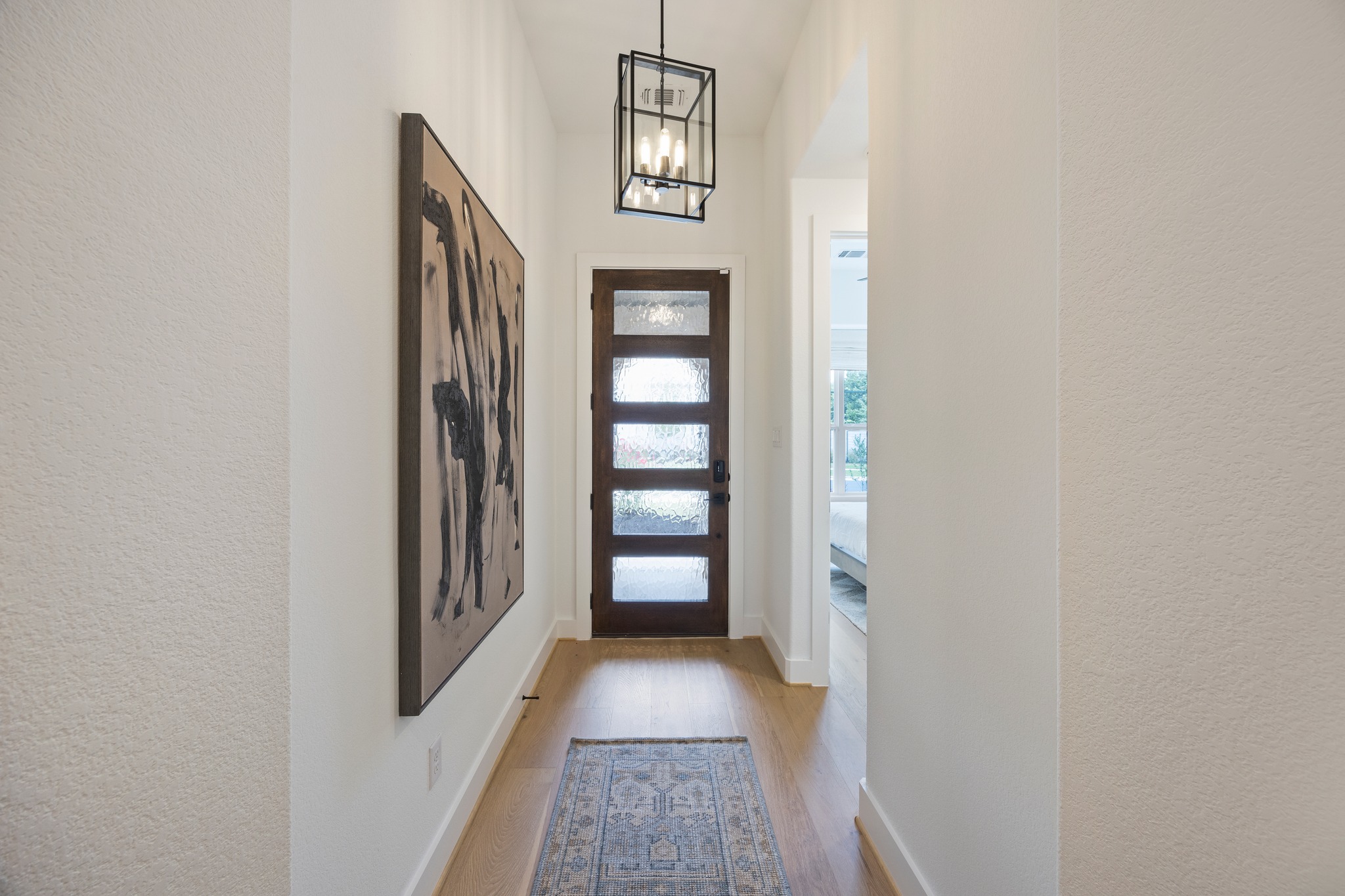 1204 Addison Lane Georgetown, TX 78628 - Photo 2 of 35 Make a grand entrance with this light-filled foyer, featuring a stunning five-lite wood door with textured privacy glass.