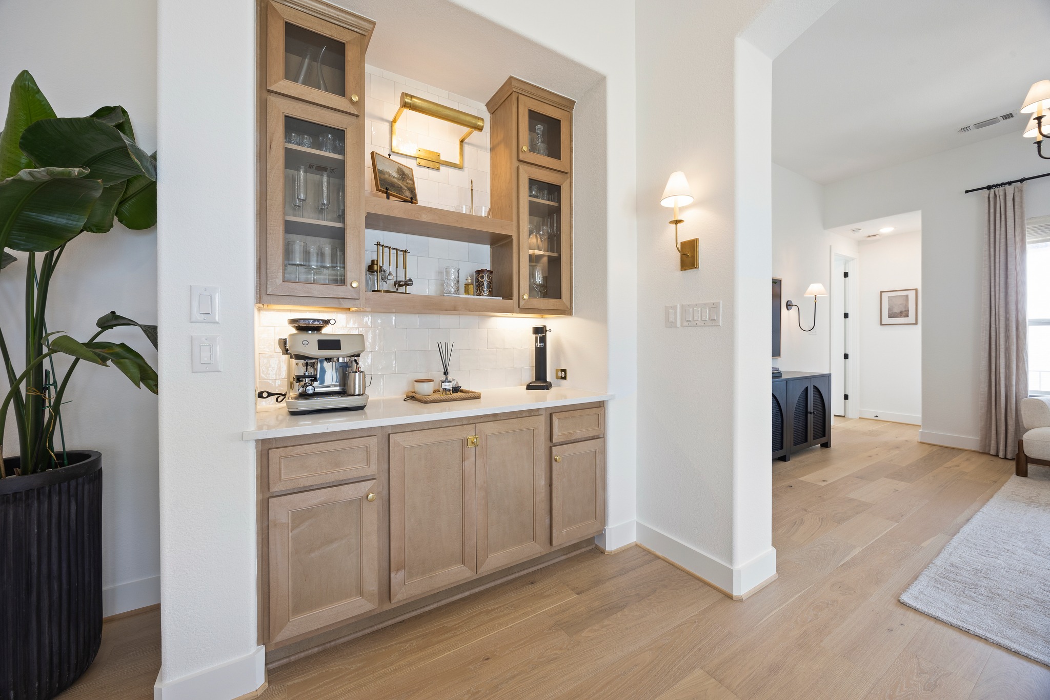 1204 Addison Lane Georgetown, TX 78628 - Photo 8 of 35 Attention to detail shines in this custom built-in hutch. Featuring white subway tile backsplash, floating wood shelving and under cabinet lighting, this alcove serves as a functional and stylish extension of the kitchen, perfect for a coffee bar or wine service.