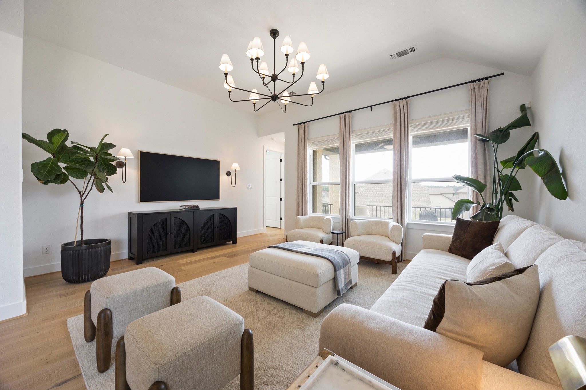 1204 Addison Lane Georgetown, TX 78628 - Photo 9 of 35 The interior is bathed in a warm glow thanks to custom lighting and dimmer switches throughout the house, complemented by customized linen curtains and window coverings that add a soft, organic texture to every room.