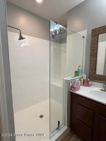 a bathroom with a mirror sink and shower