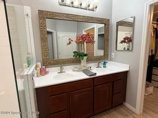 a bathroom with a double vanity sink and a mirror