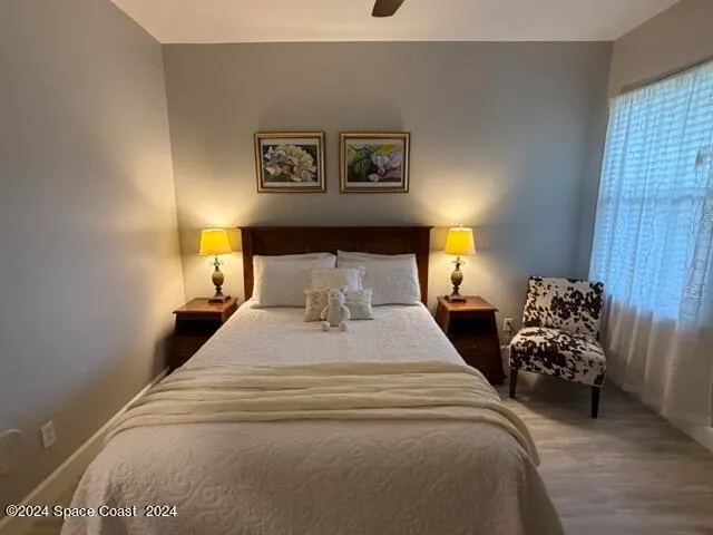 a bedroom with bed and a chandelier