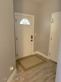 an empty room with wooden floor and closet