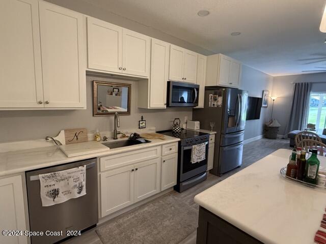 917 Ocaso Lane Rockledge, FL 32955 - Photo 4 of 22 a kitchen with a sink a stove and refrigerator