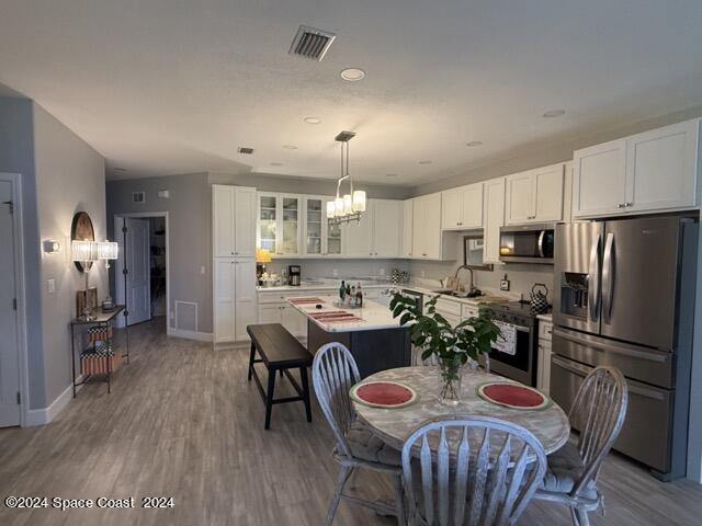917 Ocaso Lane Rockledge, FL 32955 - Photo 5 of 22 a kitchen with refrigerator a sink and chairs