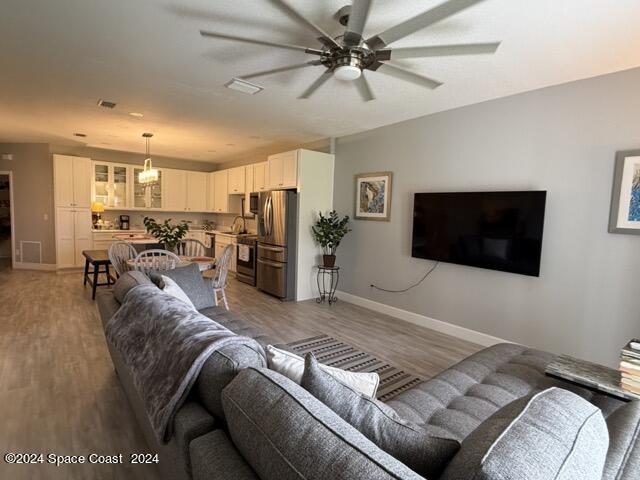 917 Ocaso Lane Rockledge, FL 32955 - Photo 6 of 22 a living room with furniture and a flat screen tv