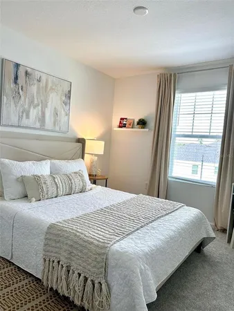 a bedroom with a large bed and a window