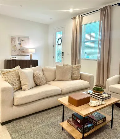 a living room with furniture and a window