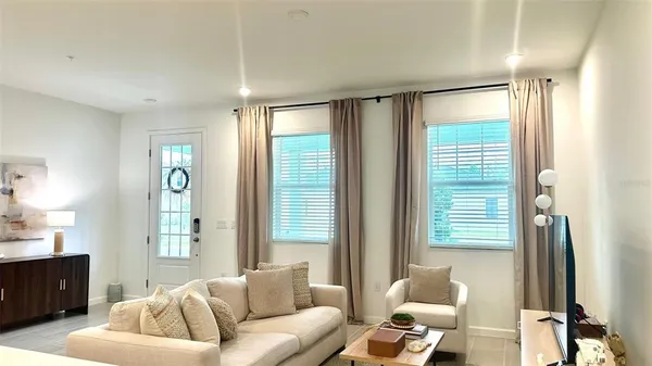 a living room with furniture and a large window