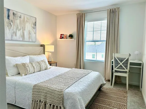 a bedroom with a large bed and a window