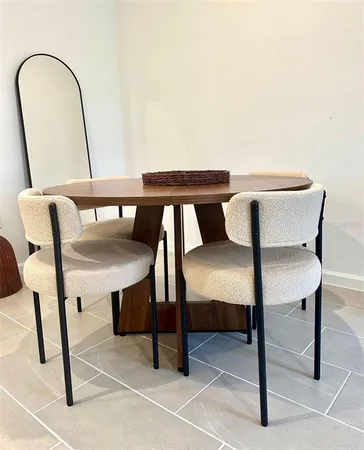 a balcony with table chairs and wooden floor