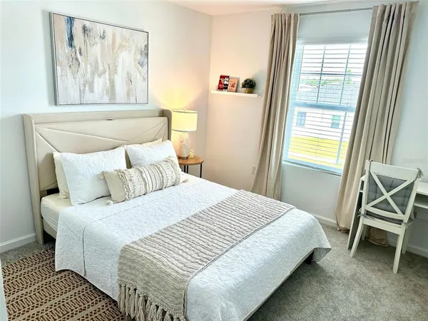 a bedroom with a bed and a window