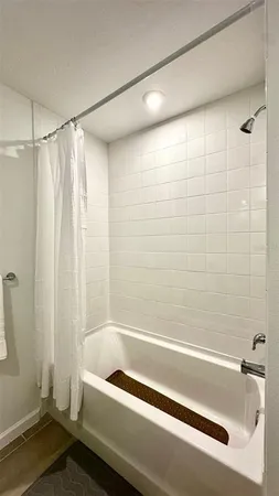 a bathroom with a bathtub and a shower