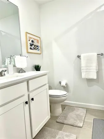 a bathroom with a sink toilet and a mirror