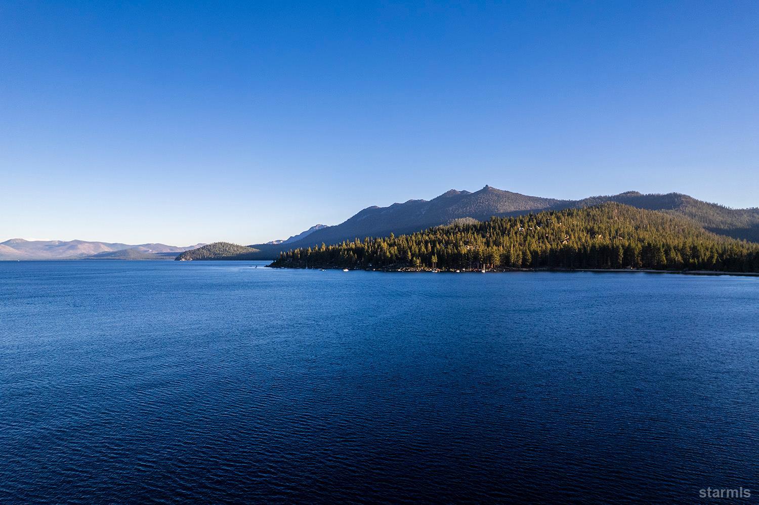 255 Drum Road Meeks Bay, CA 96142 - Photo 4 of 19 a view of a lake with mountains in the background