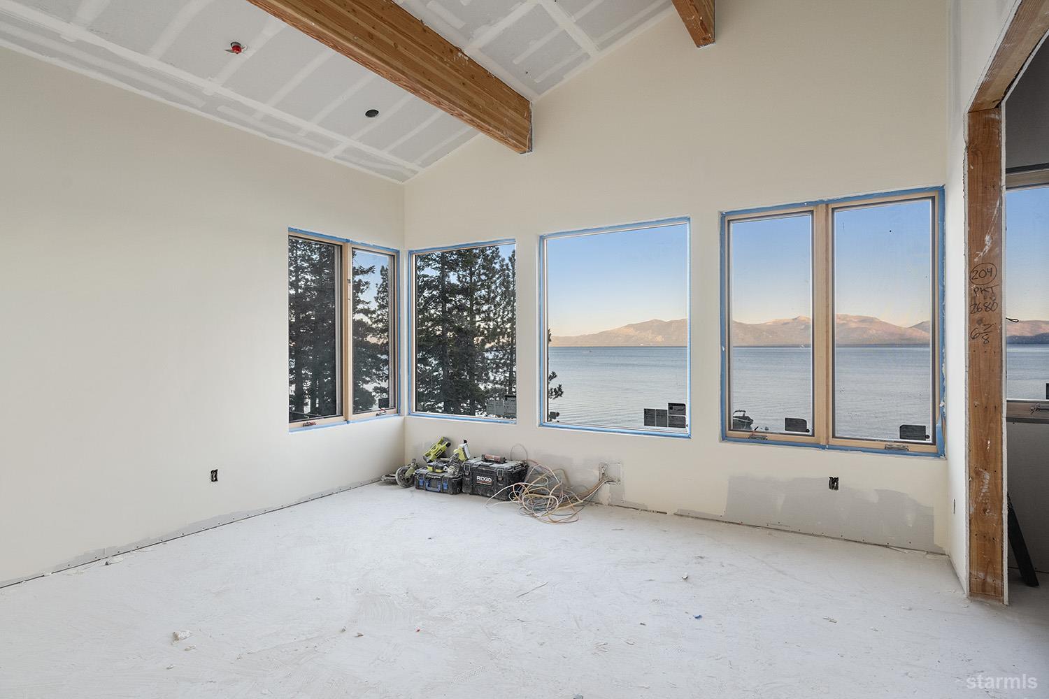 255 Drum Road Meeks Bay, CA 96142 - Photo 9 of 19 an empty room with a large window and glass door