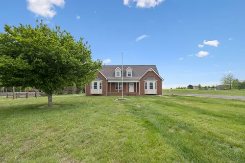 a view of a big yard with a house in the background