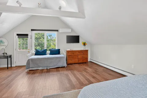 a bedroom with a bed and window