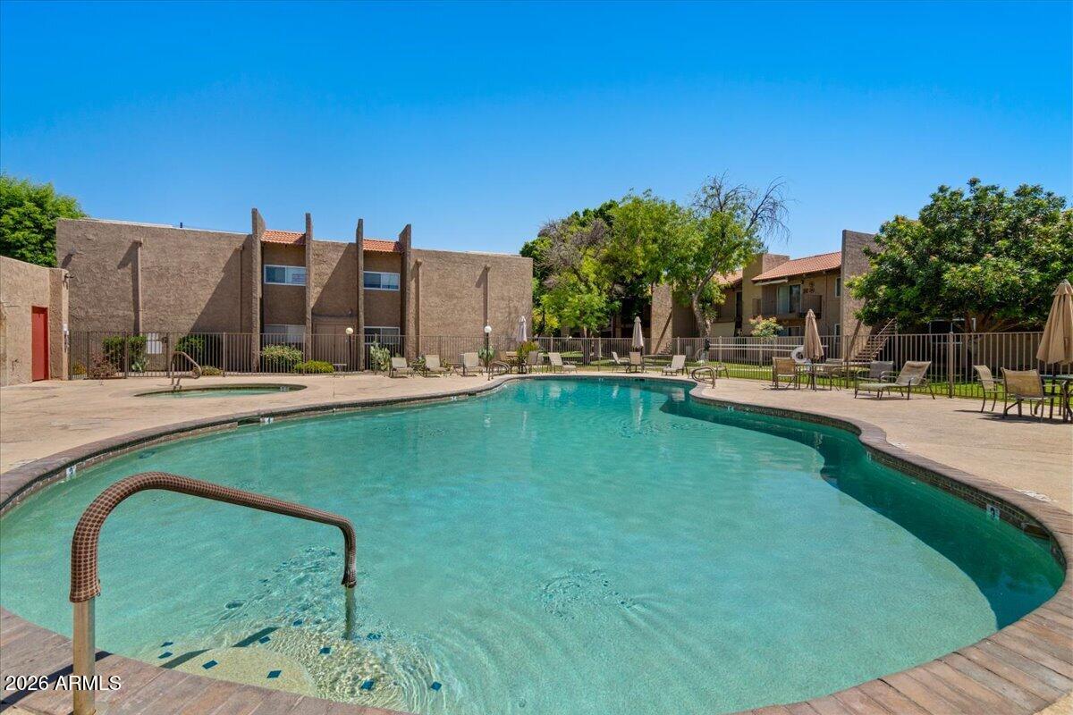 5525 East Thomas Road, Unit O12 Phoenix, AZ 85018 - Photo 17 of 27 a swimming pool with outdoor seating and yard
