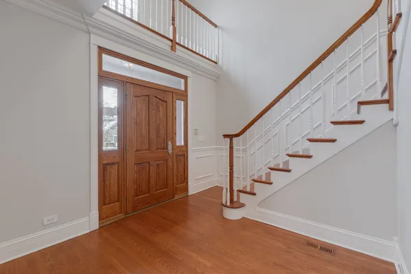 a view of an entryway with wooden floor