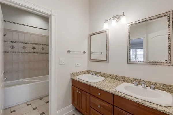 a bathroom with a granite countertop sink mirror and shower