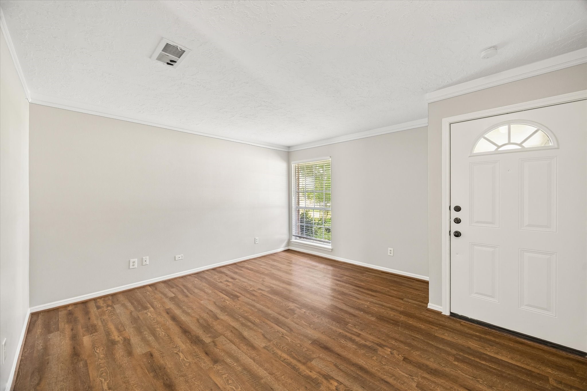 25114 Spring Ridge Drive Spring, TX 77386 - Photo 4 of 24 an empty room with wooden floor and windows