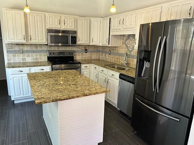 a view of a kitchen with a sink and dishwasher