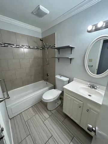 an empty room with wooden floor chandelier fan and windows