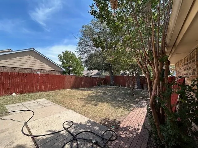 a view of a house with a yard and tree