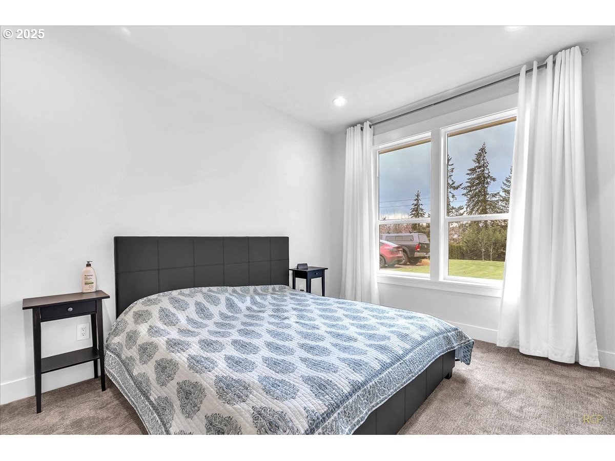 31001 Northwest 51st Avenue Ridgefield, WA 98642 - Photo 22 of 48 a bedroom with a large bed and a large window