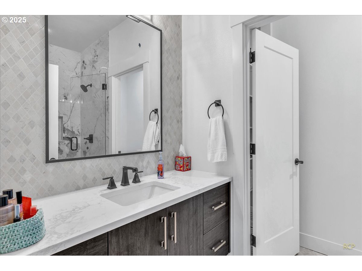 31001 Northwest 51st Avenue Ridgefield, WA 98642 - Photo 30 of 48 a bathroom with a sink vanity and a mirror