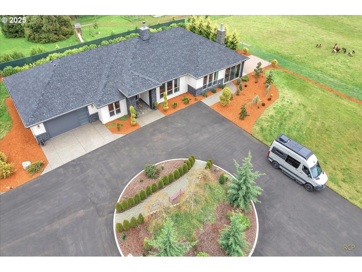 31001 Northwest 51st Avenue Ridgefield, WA 98642 - Photo 8 of 48 an aerial view of a house with a garden and swimming pool