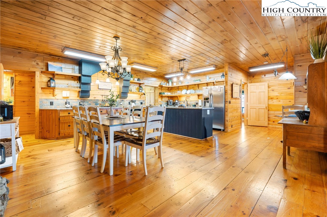 1748 Junaluska Road Boone, NC 28607 - Photo 18 of 37 a view of a dining room with furniture and wooden floor