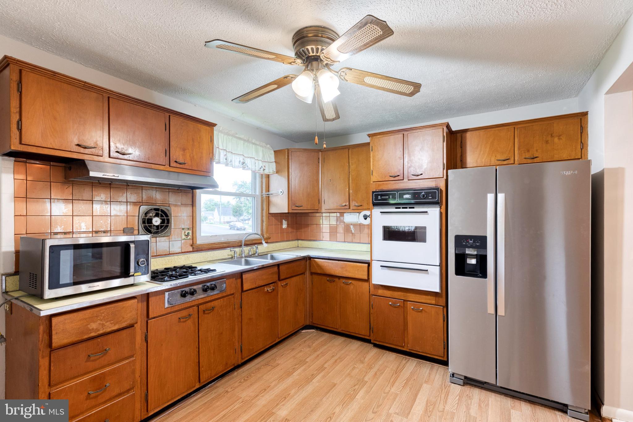 8306 Berkfield Road Baltimore, MD 21237 - Photo 14 of 29 Charming kitchen with classic wood cabinetry.