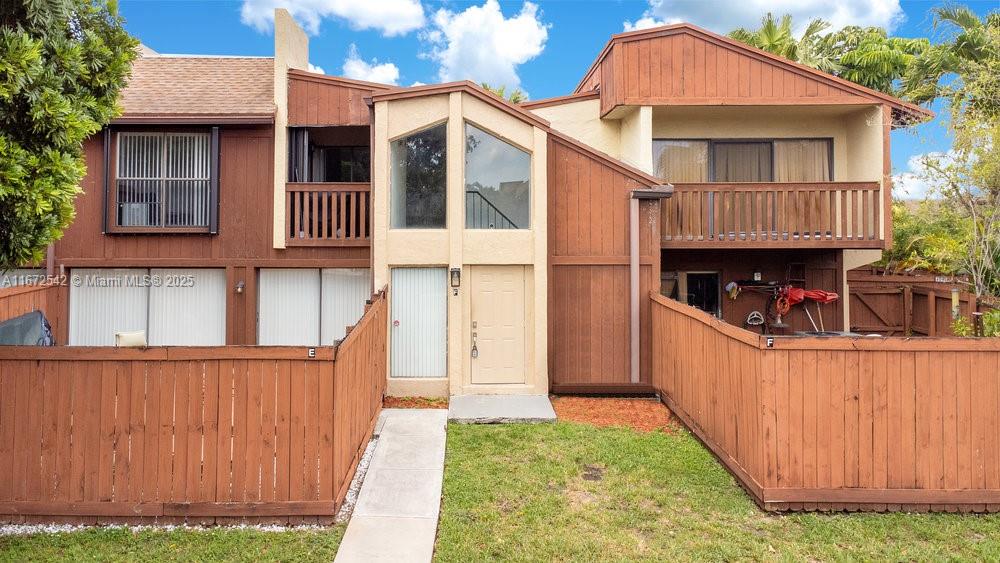 a front view of a house with garage