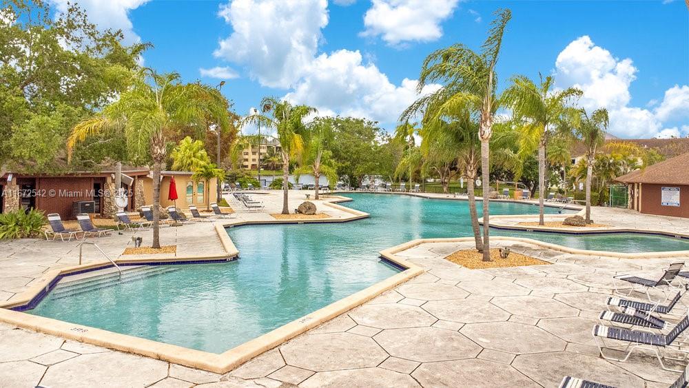 6604 Southwest 114th Place, Unit F72 Miami, FL 33173 - Photo 20 of 25 a view of a swimming pool with lounge chairs